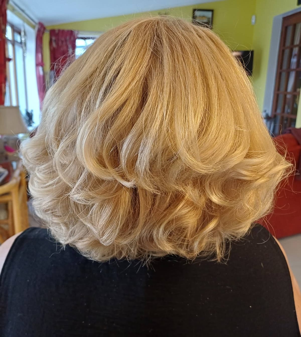 Voluminous curly blow dry on a blonde bob